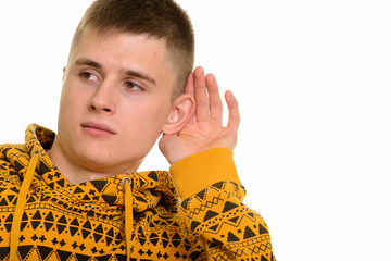 Curious Caucasian man cupping ear and listening