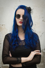 Rock girl with blue hair on a city street