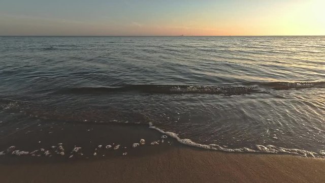 Calm water - sea waves at the beach at the morning sunrise around 6a - close up. Baltic sea.