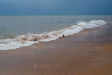 White sand beach with waves and blue sky on cold summer day in Latvia, Pavilosta