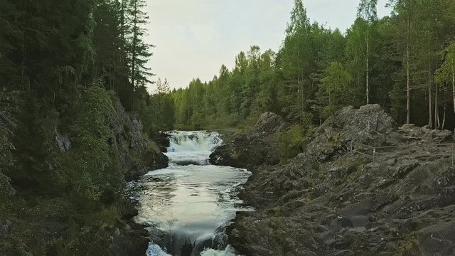 Aerial footage of a Karelian waterfall Kivach, full water flow over the top