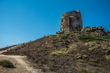 Tower of San giovanni of corinthian ruins of Tharros village  on a beautiful clear sunny day in Sinis peninsula, Cabras, Oristano, Sardinia, Italy.