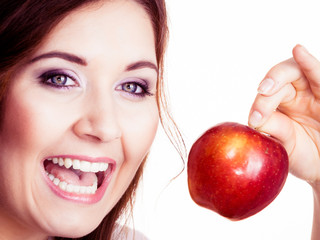 Woman holds apple fruit close to face, isolated