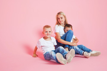 happy mom with two happy sons. Young woman and two baby boys