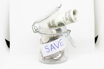 Coins in glass jar for money saving financial concept on white background.