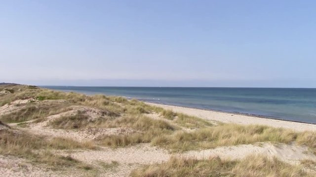 Liseleje Beach by Tisvilde forest and coastal area on the Danish island of Zealand. A pristine morning overlooking the sand dunes. Springtime with a sunny clear blue sky.
