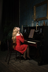 Beauty woman in evening dress playing piano