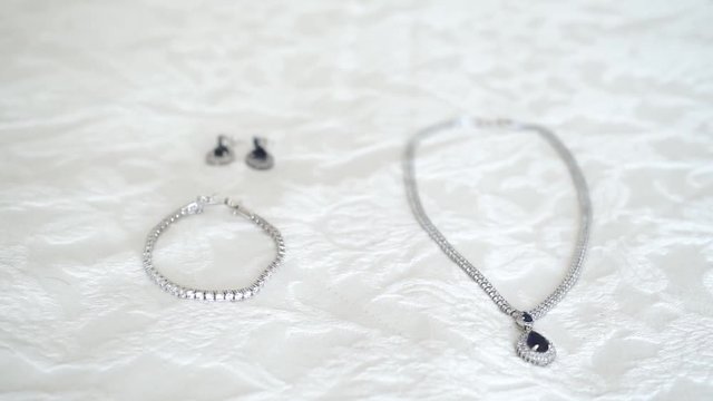 close up shot of jewelry in a white bed sheet