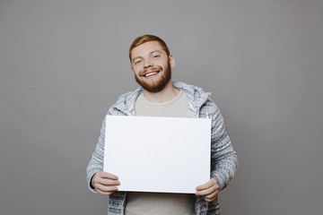 Cheerful man showing empty poster