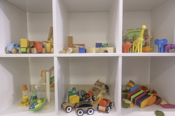 White Shelves with wood children's toys.