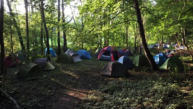 camping in the forest
juna 6 pm the french alps
alternative festival opens and campers aure taking place. Panoramic shot