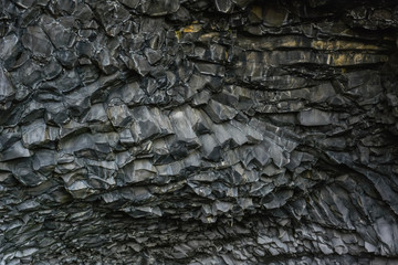 Basalt stone columns close-up on Reynisfjara black beach near  Vik town, Iceland. Texture and...