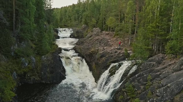 Aerial footage of a Karelian waterfall Kivach, full water flow over the top, beautiful nature, foam on water
