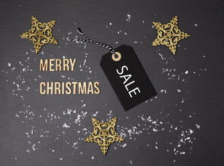 Fototapeta na wymiar Merry Christmas black background and price label. Black Friday. Sales concept. Copy space. Black paper label against a dark grey background. Black Friday shopping sale concept 