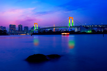 Fototapeta na wymiar Colorful illuminations at Rainbow Bridge from Odaiba in Tokyo, Japan