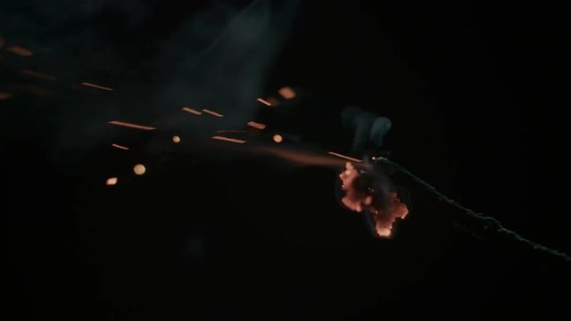 Fuse is ignited by a burning match.