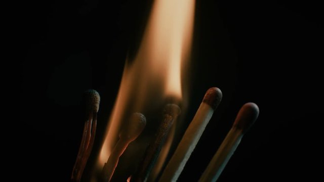 Burning matches close-up over black background.
Chain effect.
