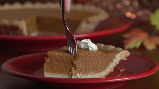 Cutting bite of pumpkin pie