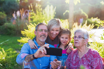 A family with three generations does a selfie for memories