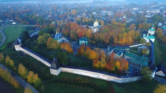 October morning over the Holy Dormition Pskov-Pechersk monastery (aerial video). Pechory, Russia