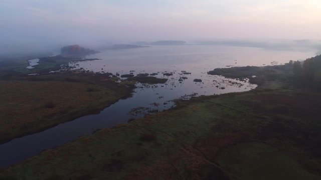 View of the mouth of the river Sorot and lake Kuchane, misty morning. Pushkin Mountains, Russia (aerial video) 