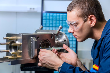 engineer with a caliper measuring device in the modern laboratory