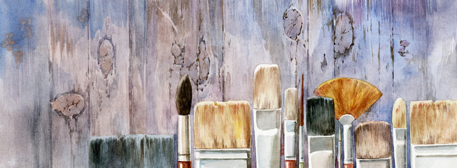 Old painting brushes, beautiful watercolor illustration. Artistic brushes on the background of wooden boards.