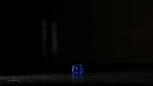 A blue dice with 4 becoming in focus