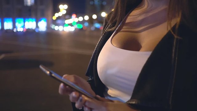 A young girl with a phone in the night city. Big breast. Close Up. Close Up. FHD
