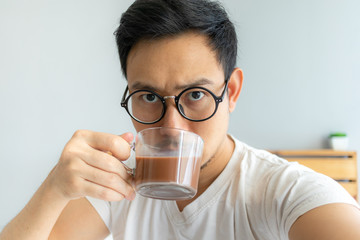 Asian man selfy himself drinks coffee.