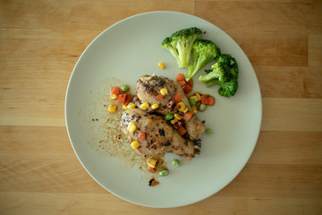 Steamed chicken legs with broccoli.