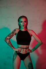 Obraz premium Tattooed girl in black lingerie cropped view