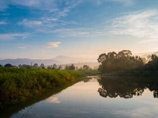 mountain forest nature and reflectation on river with blue sky sunrise in the moning, landscape concept.