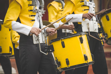 Marching band drummers perform in school parade