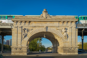 Paris, France - 10 13 2018: The Passy viaduct of Bir-Hakeim bridge and a subway, at sunrise