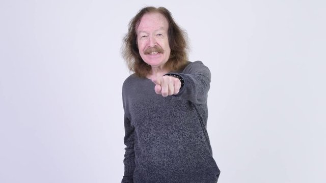 Happy senior man with mustache pointing to camera