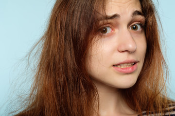 winter hairstyle problems. static hair hacks and beauty care routine. stressed woman with messy disheveled locks.
