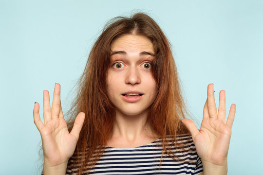 Crazy Hair Day. Morning Women Problems. Beauty And Styling Hacks. Disheveled Ruffled Young Girl Portrait On Blue Background.