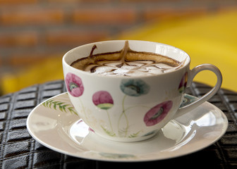Cup of cappuccino on table