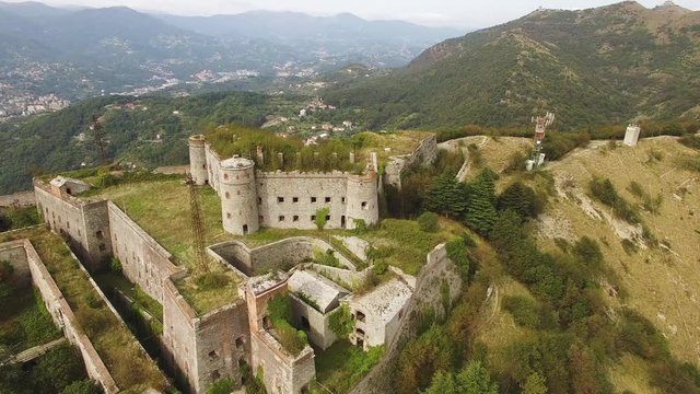 Aerial shot tilting down as camera flies over Forte Sperone in Genoa, Italy