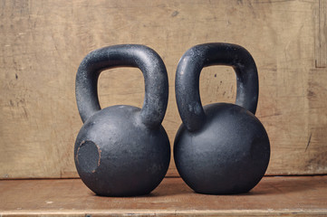 two heavy kettlebell black on wooden background