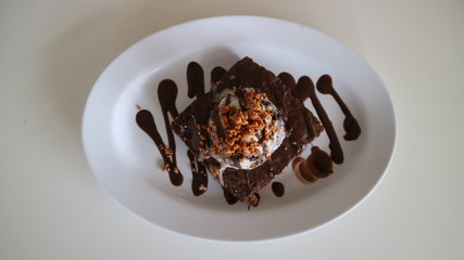 Brownies with ice cream on the white plate