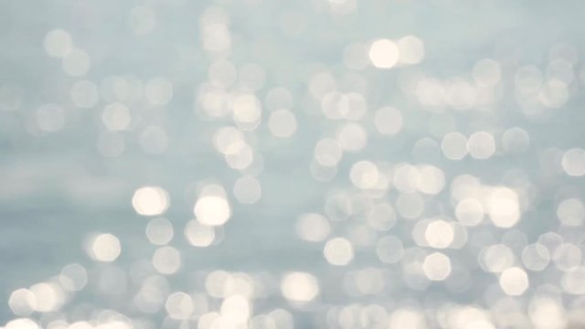 Bokeh bouncing circle lights, water reflections. Unfocused ripple water blurred sunlight reflection.