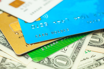 Credit cards and stack of banknotes 1 dollars in cash. Electronic money with a security chip for payment in the store. closeup