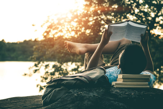 Men read books in quiet nature, concept read a books.