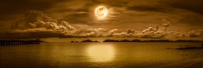 Panorama of sky with full moon on seascape to night.