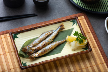 grilled shishamo served with lemon