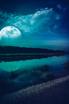 Night sky and super moon at riverside. Serenity nature background.