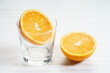 Fresh sliced orange with glass