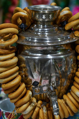 Russian tea samovar with a bunch of bagels.